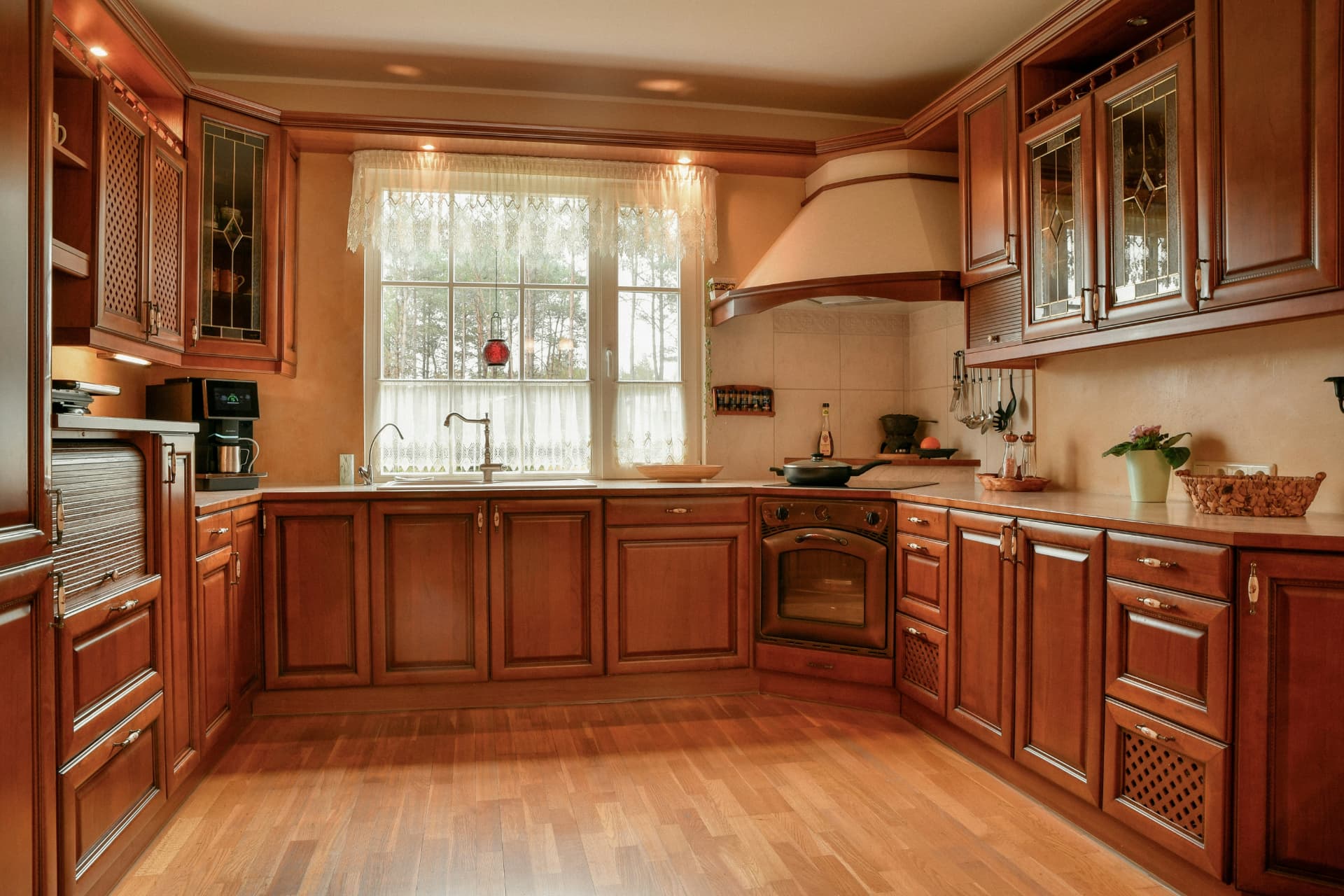 Warm stained wood kitchen cabinets with glass-front doors