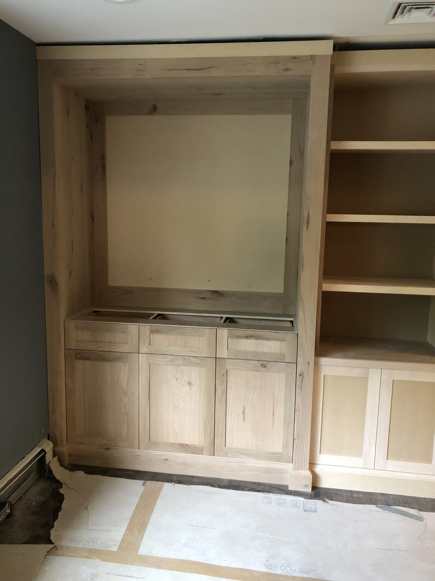 Raw, unfinished white oak bar cabinetry and built-ins before staining and finishing in Austin